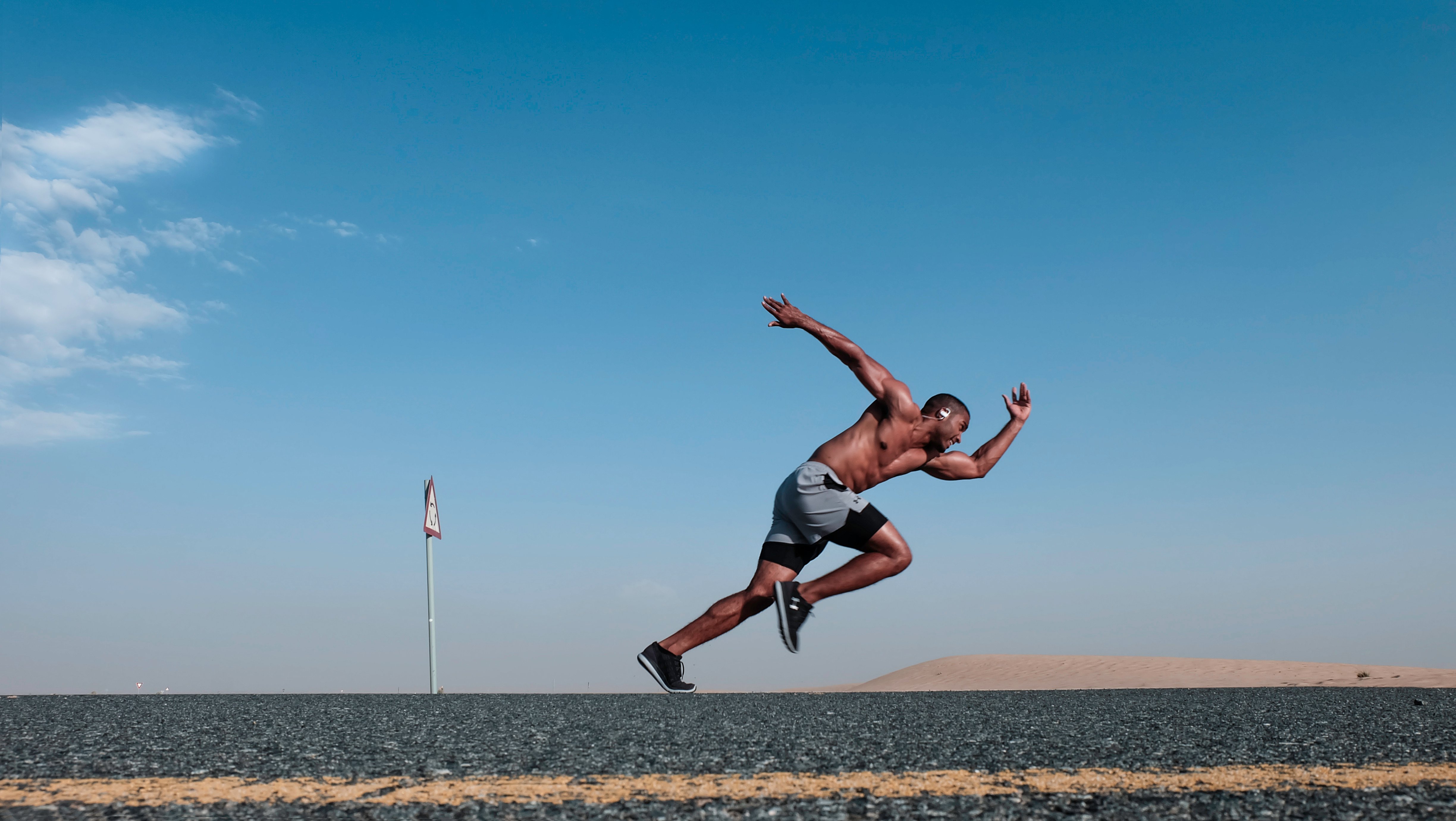 Canva - Topless Man Wearing Grey And Black Shorts Sprinting On Concrete Road Canva - Topless Man Wearing Grey And Black Shorts Sprinting On Concrete Road
